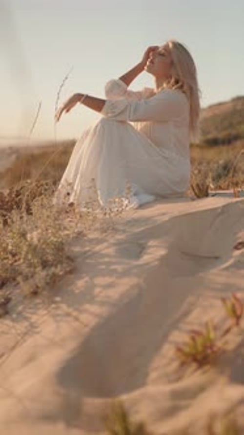Woman Sitting On Beach