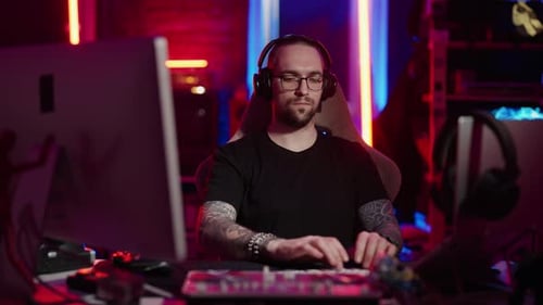 Man Gaming at Computer with Neon Lighting