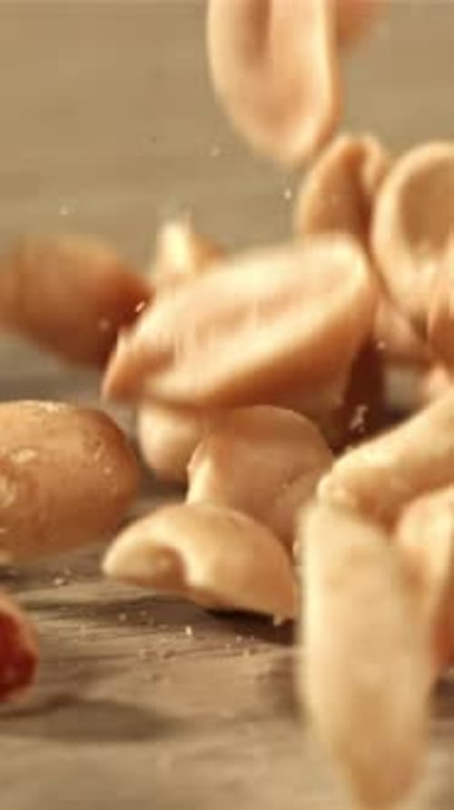 Peanuts Fall on the Table Filmed on a Highspeed Camera at 1000 Fps