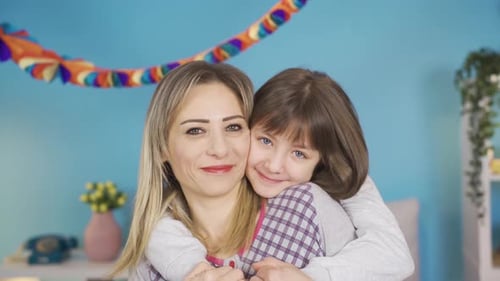 Loving Mother and Daughter Embracing in Bedroom