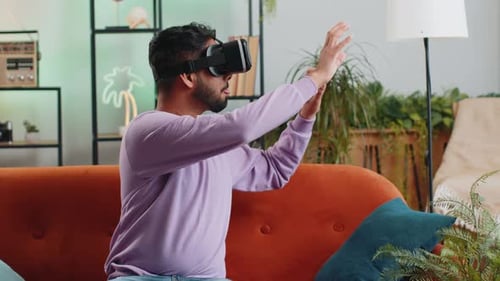 Adult Man Using Virtual Reality Headset on Couch