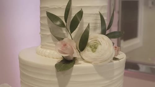 Close Up of Real Flowers on a Beautifully Decorated White Wedding Cake.