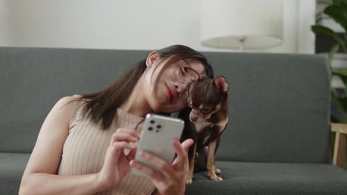 Woman Relaxing on Couch with Small Dog