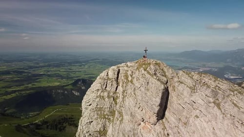 Drone flying away from a summit in the alps
