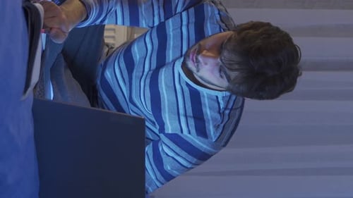 Teenager studying in bed at night and doing homework.