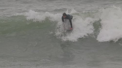 Male Surfer Riding a Wave