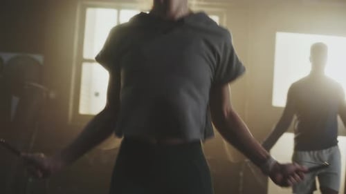 Adults Jumping Rope in a Gym