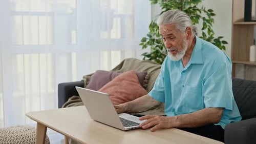 Senior Man Using Laptop for Video Conference