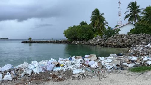 Trash pollution garbage on Rasdhoo island atoll tropical Maldives