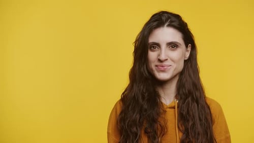 Smiling Woman Portrait in Studio with Yellow Backdrop