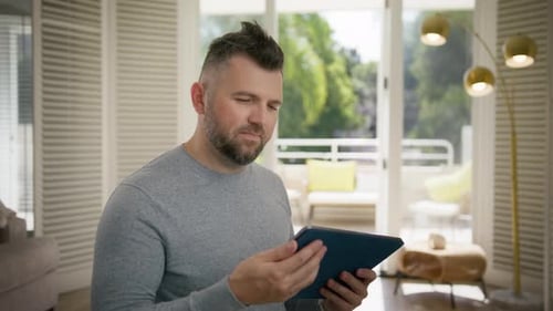 Portrait Male Professional Typing on Touch Screen Device at Apartment Workplace