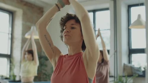 Women Practicing Yoga and Meditation Indoors