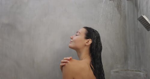 Spa Woman Under Running Water in Hot Shower