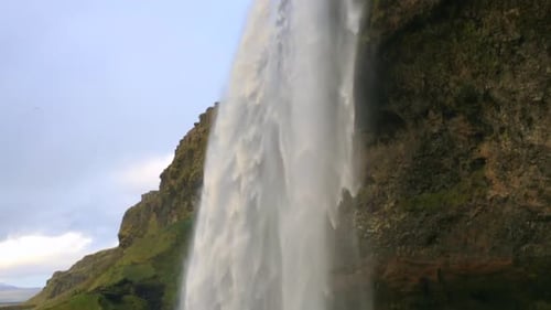 Powerful View of Seljalandsfoss Waterfall in Iceland. Great Waterfall with Cave.