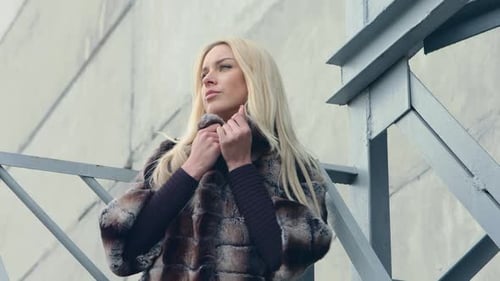 Blonde Woman in Fur Coat in Urban Setting