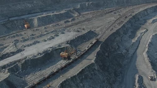 quarry aerial view. opencast mining operations. excavator loading minerals. open-pit mine.