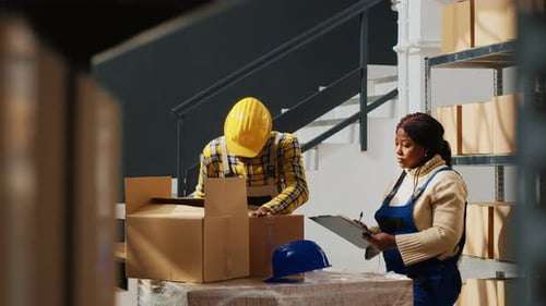 Factory Workers Packing Retail Store Goods in Boxes