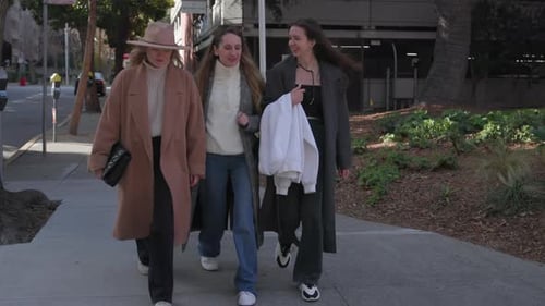 Female Friends Gossiping While Reuniting and Strolling Along Empty Street