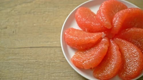 Fresh Red Grapefruit Segments on Plate