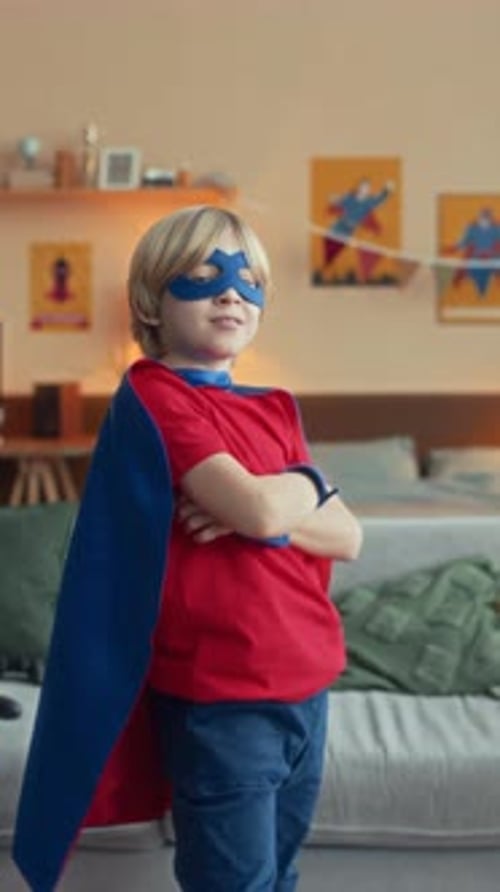 Boy Poses Proudly in Superhero Costume
