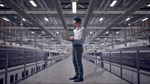 Asia Male Use Laptop at Solar Panel Factory