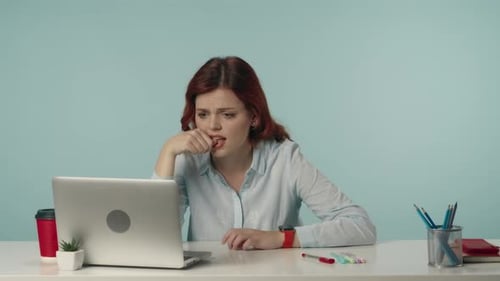 Stressed Woman Working on Laptop at Desk