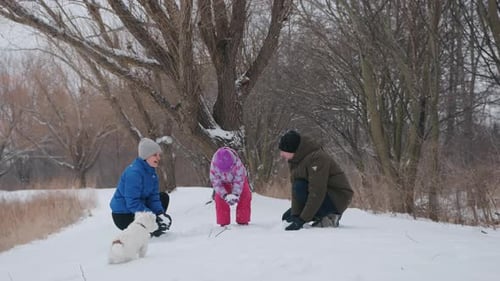 Happy Family Playing with Snow in a Park on a Sunny Winter Day Slow Motion Footag