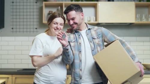 close up of the hands happy married couple holding keys to a new apartment. family bought a house