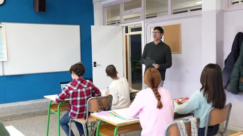 Teacher giving geography lesson to high school students