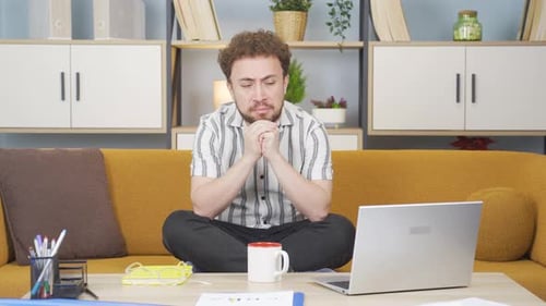 Depressed and unhappy young employee.