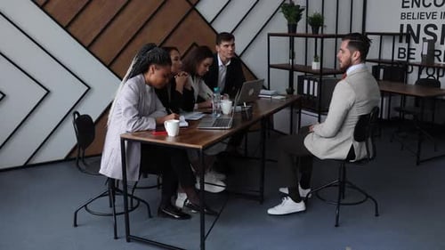 Diverse Team Meeting in Modern Office