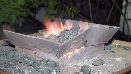 16l. Pot with heat and hot coals for metal forging.
