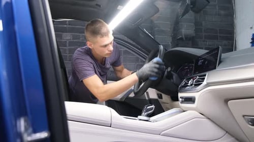 Young Adult Cleaning Car Interior