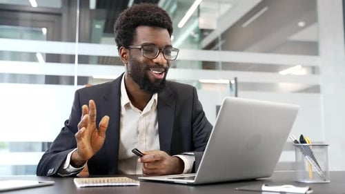 Enthusiastic Man On Video Call in Bright Office