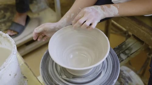 Potter Shaping Clay Bowl on Wheel with Hands