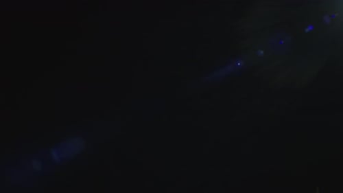 Lucent Zoom Collection: Flickering spherical lens flare with a violet hue falling along the right sh