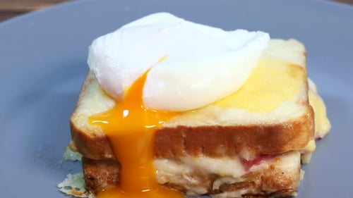 Poached egg spreads over the sandwich, Croque madame