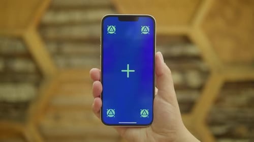 Young Woman Holding Phone Chroma Key Screen in Front of Wooden Background Girl with Green Screen on