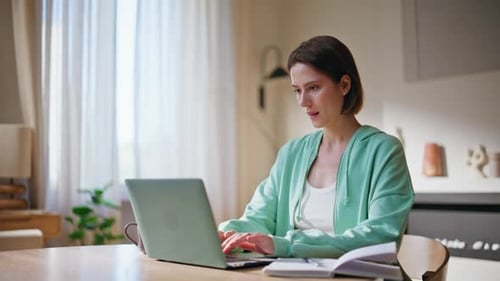 Tired Student Studying Online Looking Laptop Screen at Home Desk Closeup