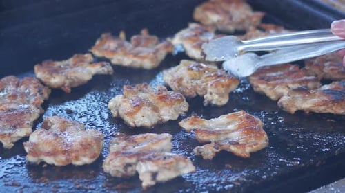 Tender and Sizzling Chicken Pieces Being Cooked on a Hot Grill