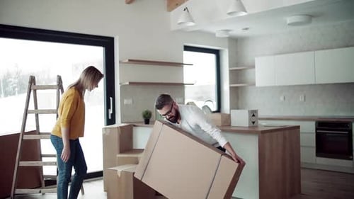 Couple Carrying Boxes in Modern Home Interior
