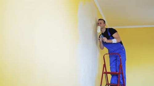 Young man in new apartment renovating room.
