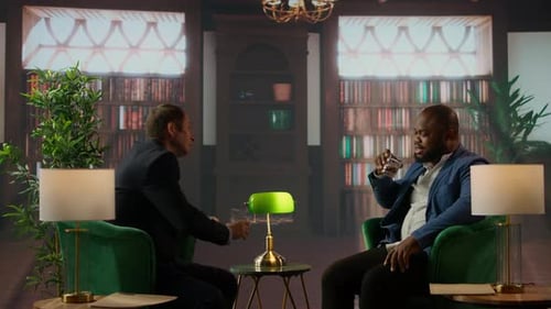 Businessmen in a Classy Library Discuss Partnership Goals Over Whiskey