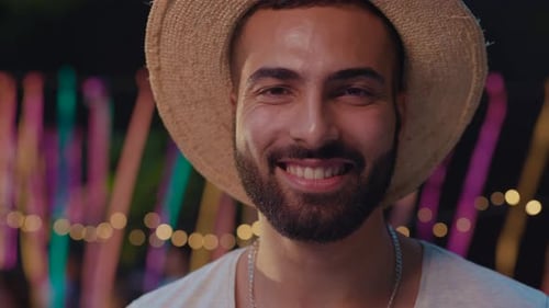 Close-up portrait of a smiling young bearded man