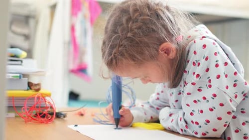 Young Girl Draws with a 3D Printing Pen