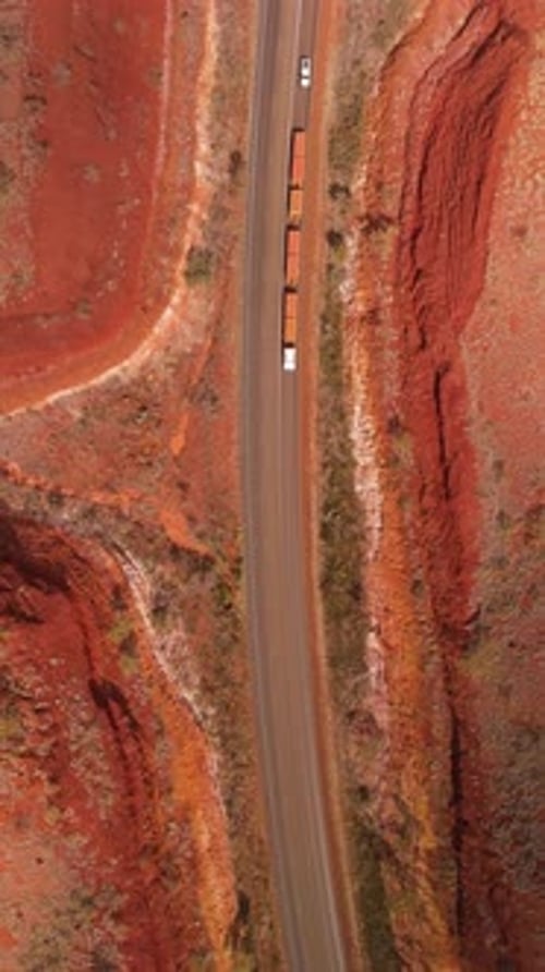 Aerial view of winding road through desert landscape, Australia.