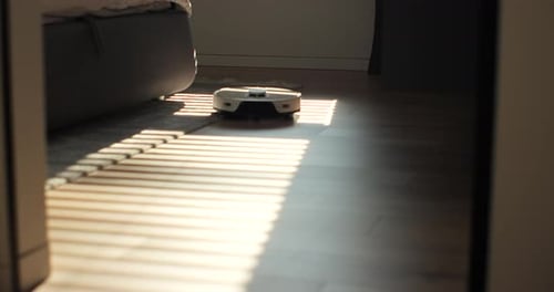 Robot Vacuum Cleaning Modern Home on Wood Floor