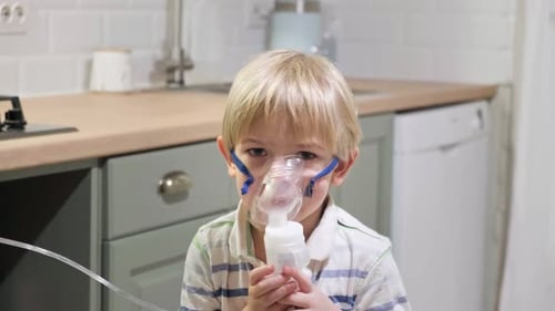 Child Using Nebulizer Mask for Respiratory Treatment