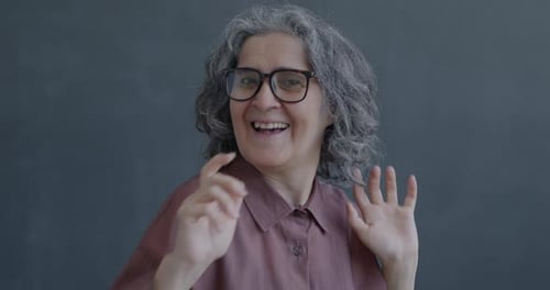Slow Motion Portrait of Happy Senior Woman Looking at Camera and Dancing Singing