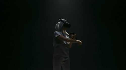 Woman with VR Headset and Controllers in Dark